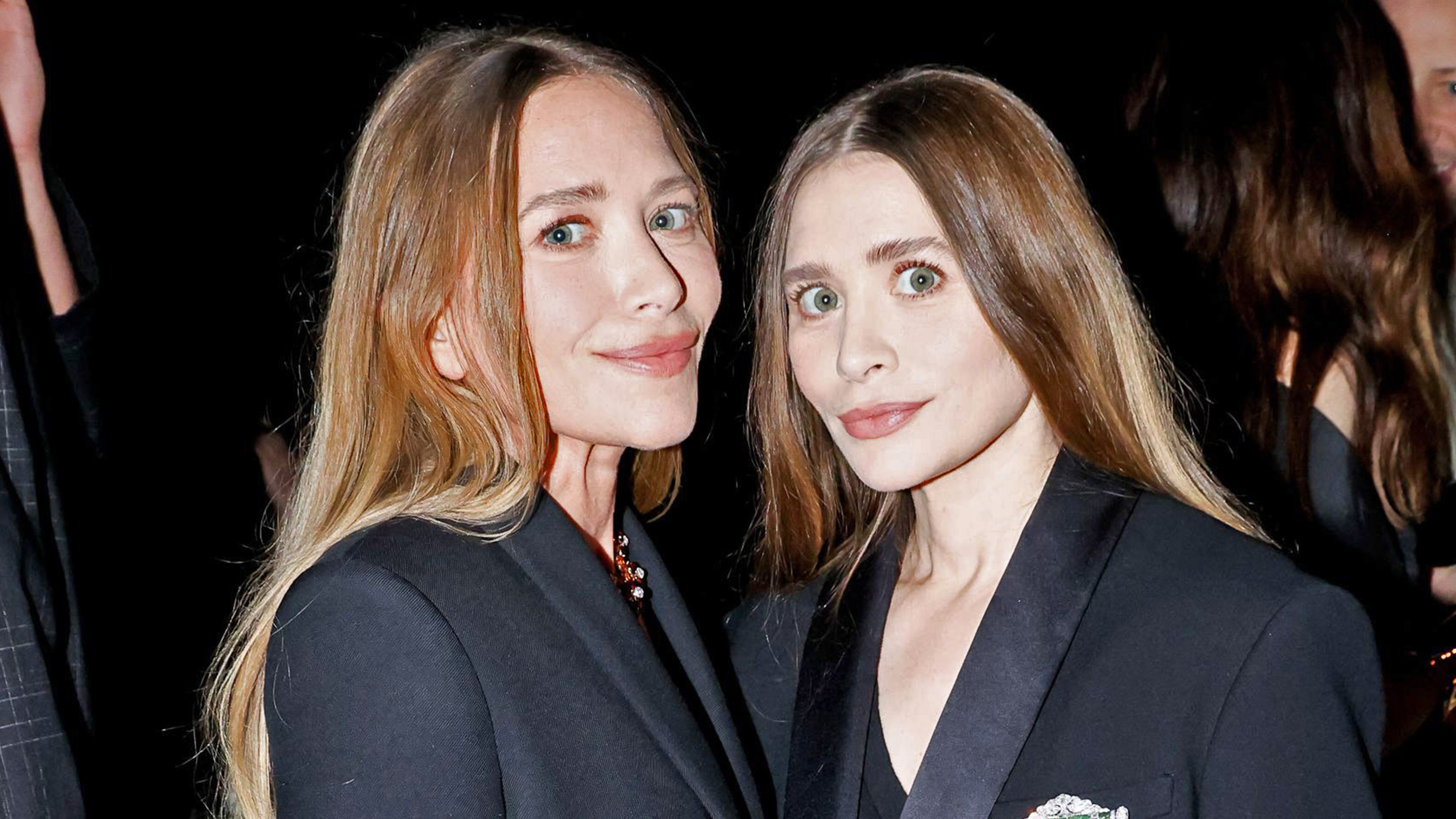 Ashley and Mary-Kate Olsen wearing matching black coats at the 2025 CFDA Awards in New York City.