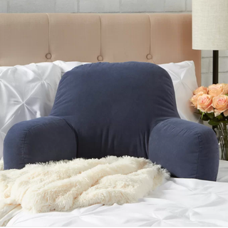 A navy blue reading cushion in a bedroom