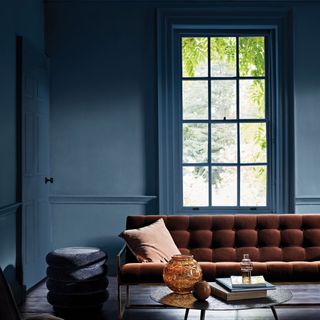 Living room with walls and window frames painted in deep blue