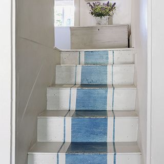 white wall and white steps with blue pattern design
