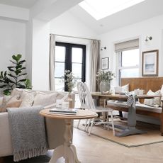 extension with white walls black framed patio doors with dining and living area in a kitchen diner
