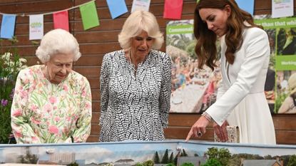 st austell, england june 11 queen elizabeth ii l, camilla, duchess of cornwall c and catherine, duchess of cambridge r look at a scale model of big lunch events that have been held over the years during an event in celebration of the big lunch initiative at the eden project during the g7 summit on june 11, 2021 in st austell, cornwall, england uk prime minister, boris johnson, hosts leaders from the usa, japan, germany, france, italy and canada at the g7 summit this year the uk has invited india, south africa, and south korea to attend the leaders' summit as guest countries as well as the eu photo by oli scarff wpa pool getty images