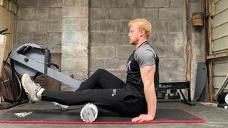 Our tester using one of the best foam rollers, the Lululemon Double, on their left hamstring
