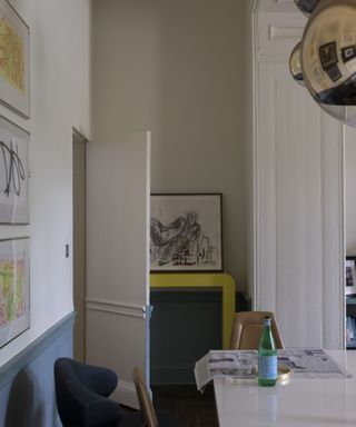 Detail of dining area with white table and blue wainscoting. Ground-?oor apartment of a Hertfordshire manor house, home of former model Joanna Shipton, husband Mark and their three children.