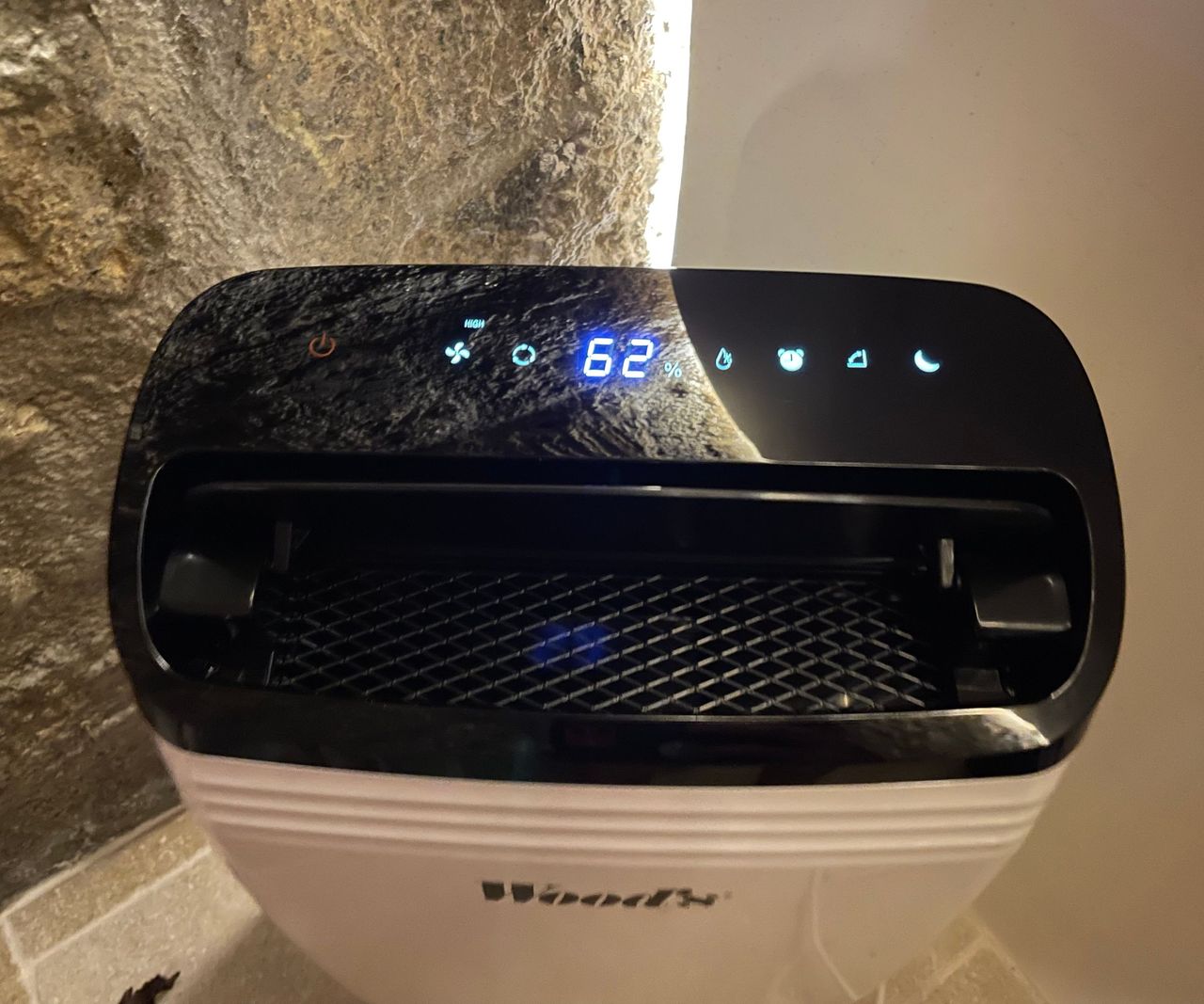 Wood's MDK26 dehumidifier in the cellar, reading a humidity level of 62 on the screen