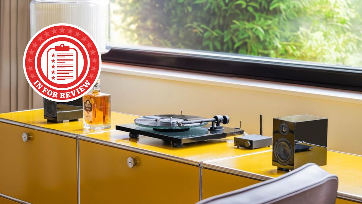 In For Review logo over yellow turntable system on table