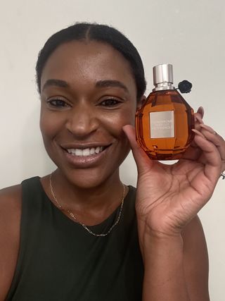 Deena Campbell holding a bottle of Viktor & Rolf Tiger Lily in her left hand.