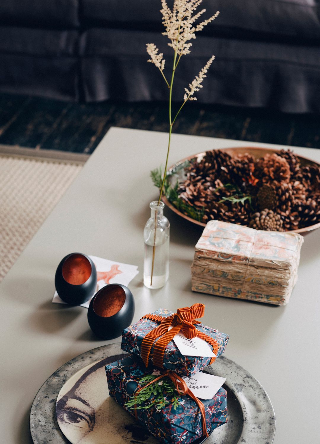 picture of bowl of pinecones on coffee table with presents