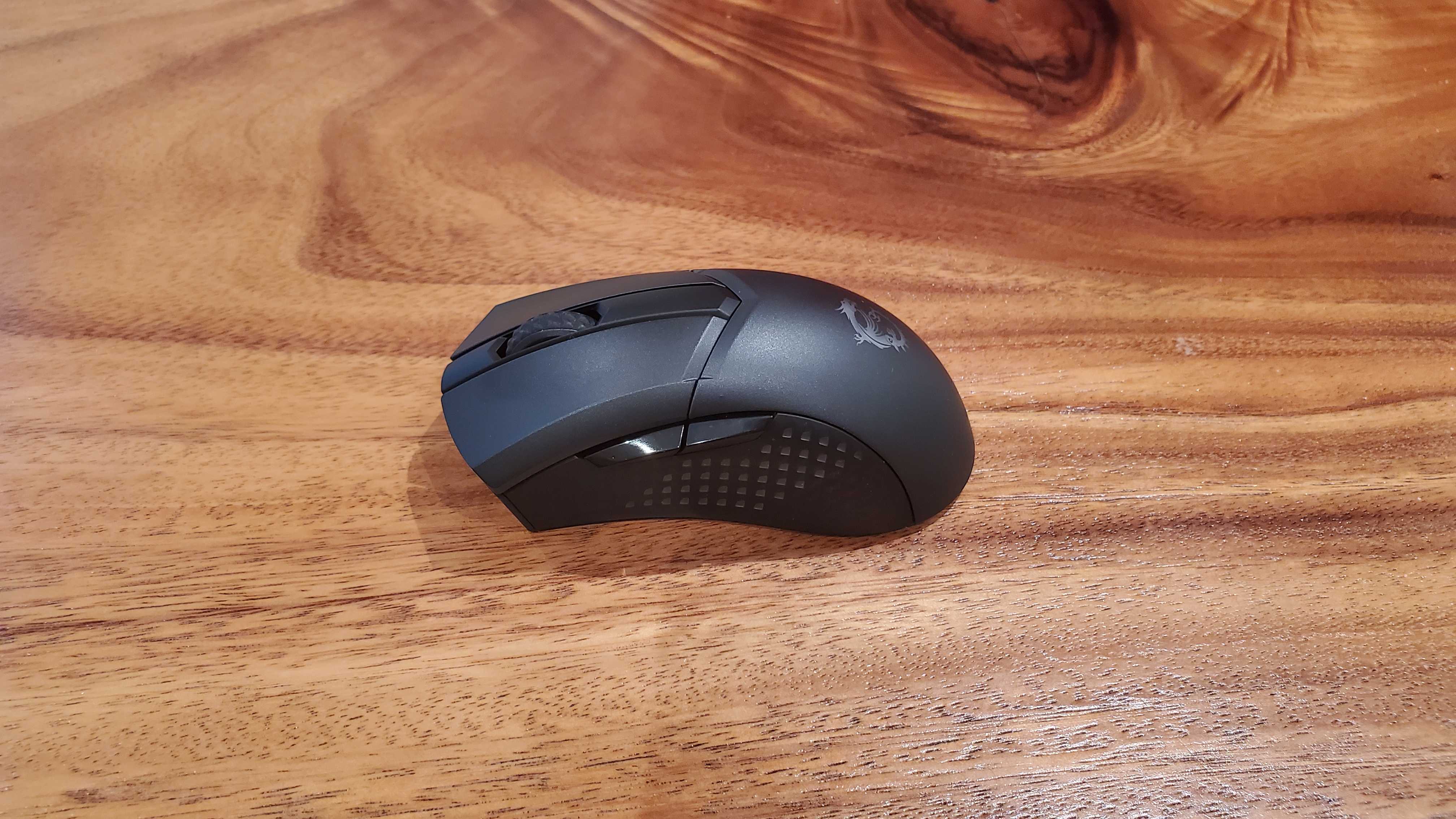 black gaming mouse on a wooden table