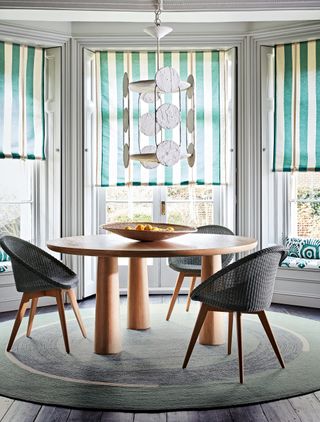 Homes & Gardens Global nomad decorating round dining table and round rug in bay window