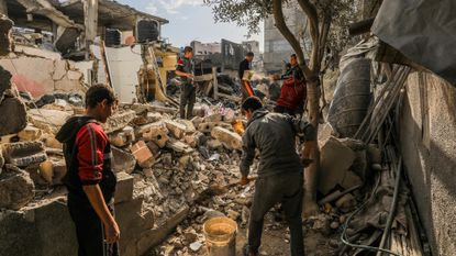 Palestinians pick through the rubble of their homes after Israel hit Gaza with air strikes