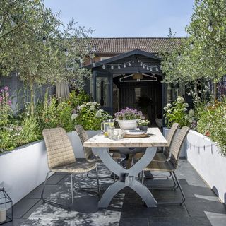 patio area with dining table and flowers