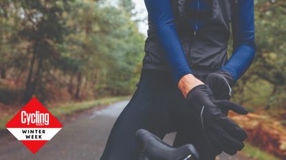Image shows a rider wearing gloves to avoid cold hands while cycling.