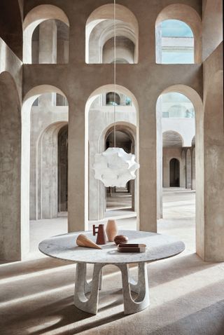 Arches form the backdrop to a round marble table