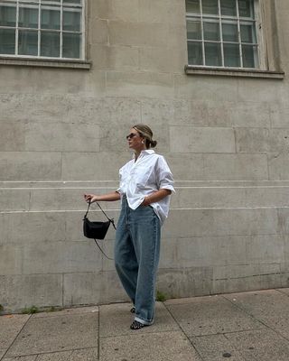 Alexis Foreman in white shirt and jeans.