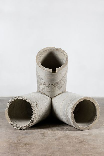 A three-way concrete pipe lying on its side