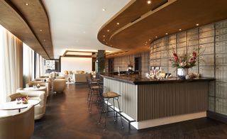 Hotel bar and stools as well as leather seating areas