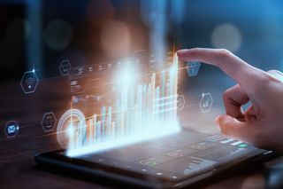 Managed services revenues story illustrated by a digital render of bar charts as a hologram above a tablet, with a hand reaching over to interact with the data