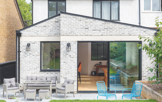 View of the extension from the back of the house with patio out the back