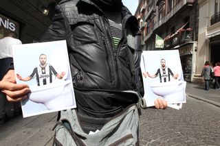 A street vendor sells images of Gonzalo Higuain in a toilet bowl following his move from Napoli to Juventus in 2016.
