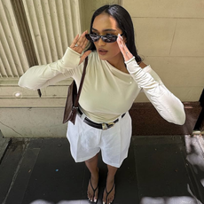 woman wearing white trouser shorts and belt