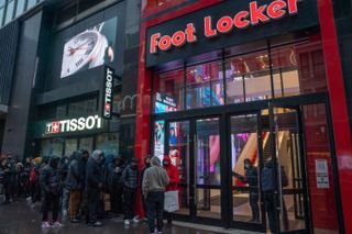 A Foot Locker store with a queue outside