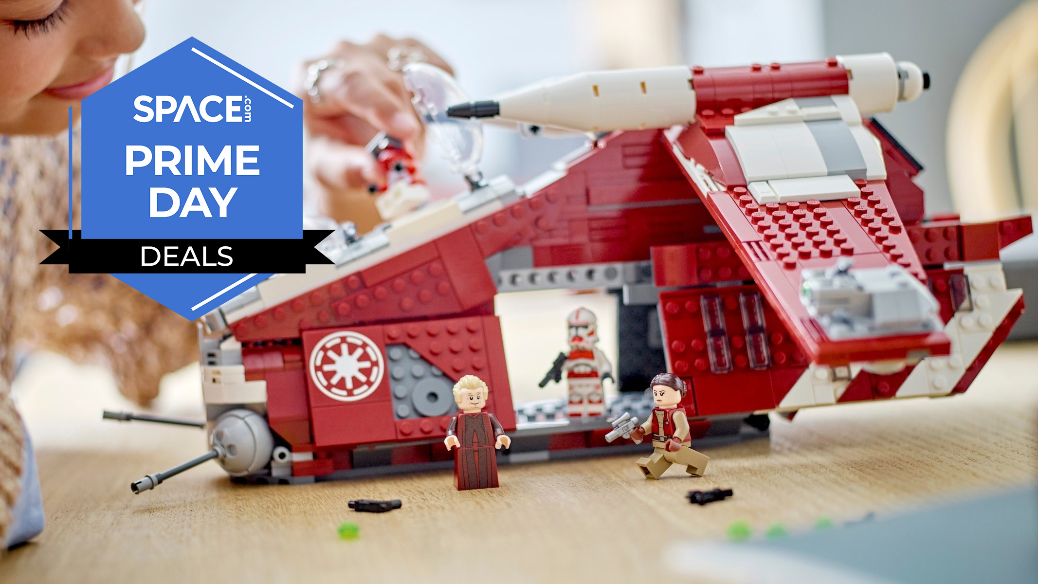 A girl playing with a LEGO Star Wars: The Clone Wars Coruscant Guard Gunship on a table. 
