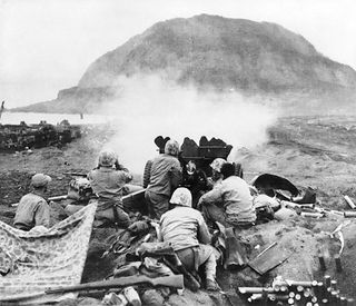37mm Gun fires against cave positions in north face of volcano in support of RCT 28. These light but extremely accurate weapons did some of their best work in the southern part of the island