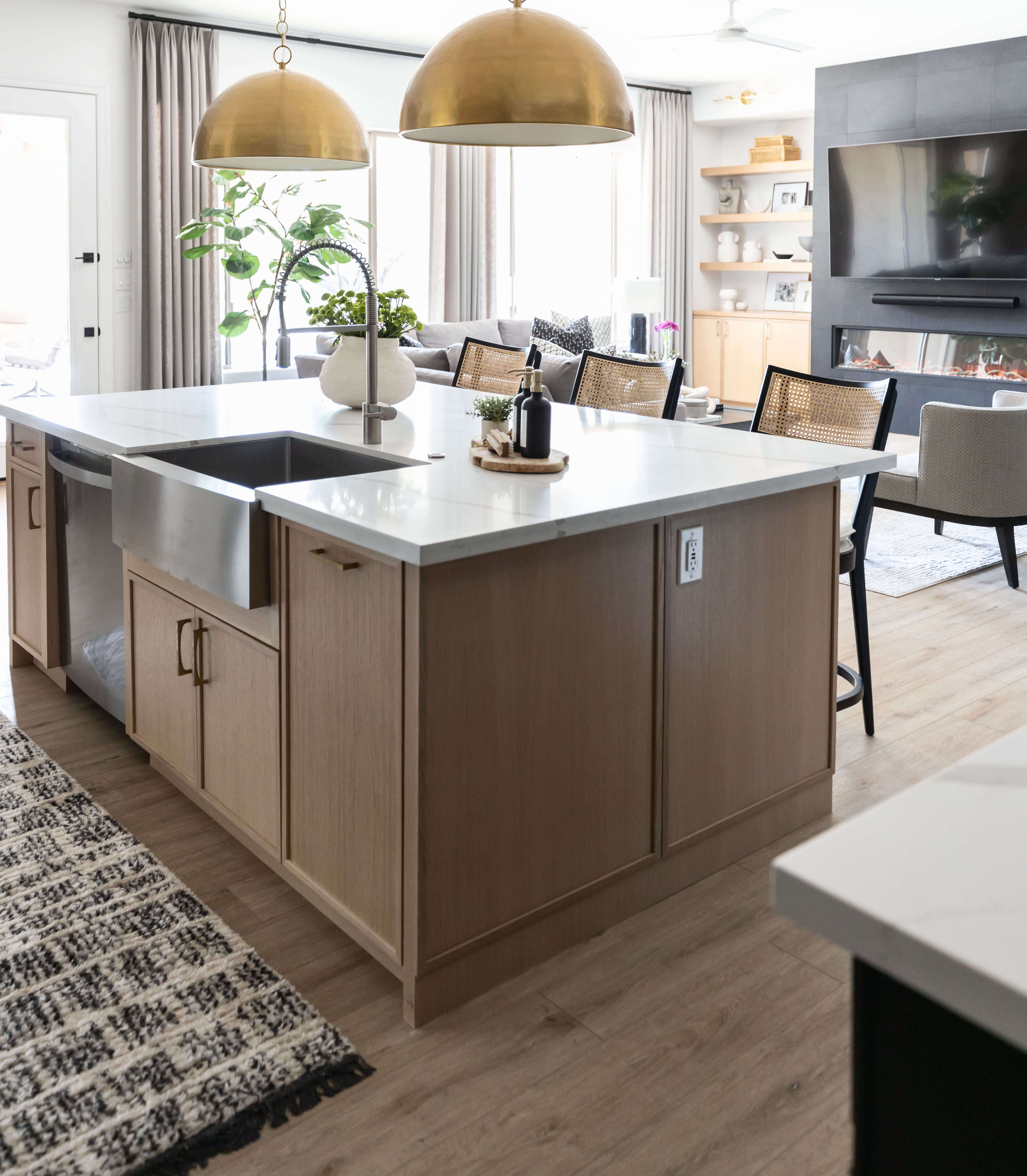 A kitchen island in wood, with a white socket on the side of the island