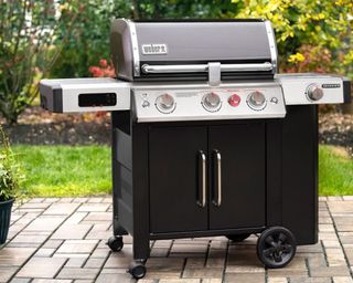 Weber Genesis II EX-335 GBS smart barbecue in backyard exterior setting