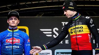 Wout van Aert attempts to shake hands with Mathieu van der Poel on podium after cyclocross race