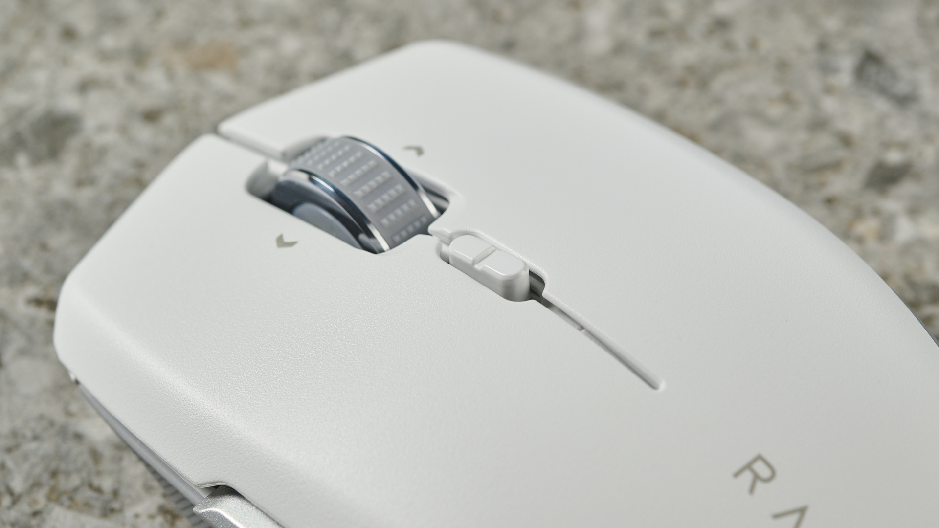 A close-up of the scroll wheel on a white Razer Pro Click Mini wireless mouse