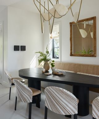 dining nook with black table and bench seat