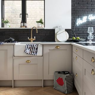 kitchen with brick wall and cabinets