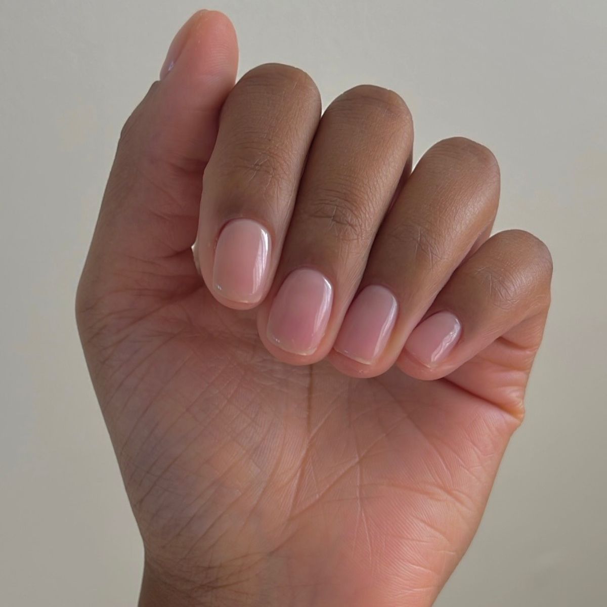 A close-up picture of a short, natural-looking manicure