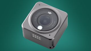 The DJI Action 2 action camera on a green background