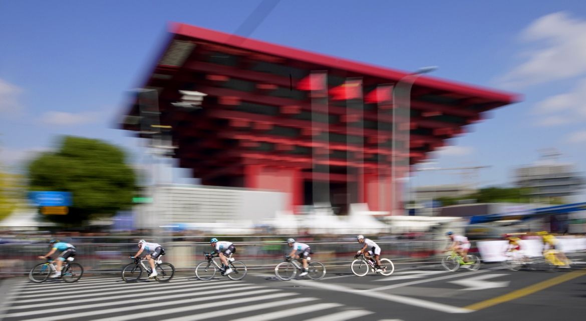 The peloton speeds through a corner