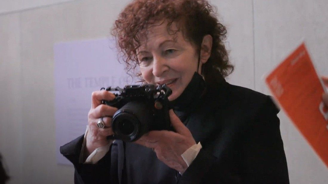 Nan Goldin holding a camera