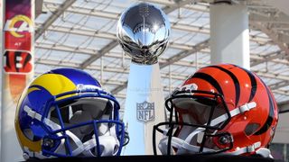 Helmets of the Los Angeles Rams and Cincinnati Bengals sit in front of the Lombardi Trophy