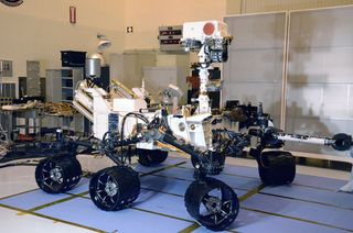 The Curiosity Mars Science Laboratory (MSL) inherited many design elements from the earlier Mars Exploration Rovers Spirit and Opportunity, including six-wheel drive, a rocker-bogie suspension system and cameras mounted on a mast to help the mission's