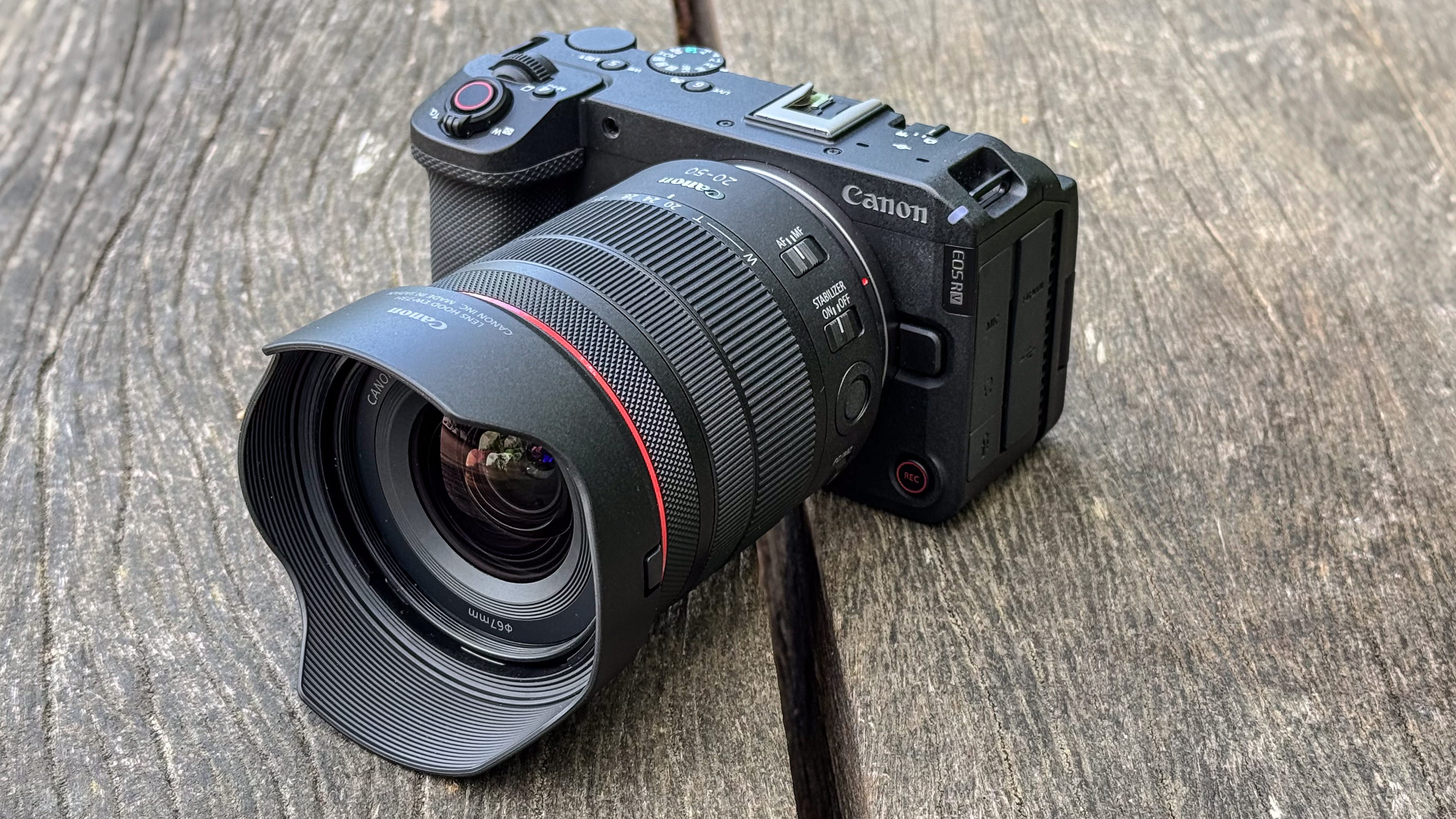 Canon EOS R6 V with the Canon RF 20-50mm f/4L IS USM PZ on a wooden surface