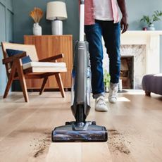 Image of Vax Evolve being used on hard floors in promo image 