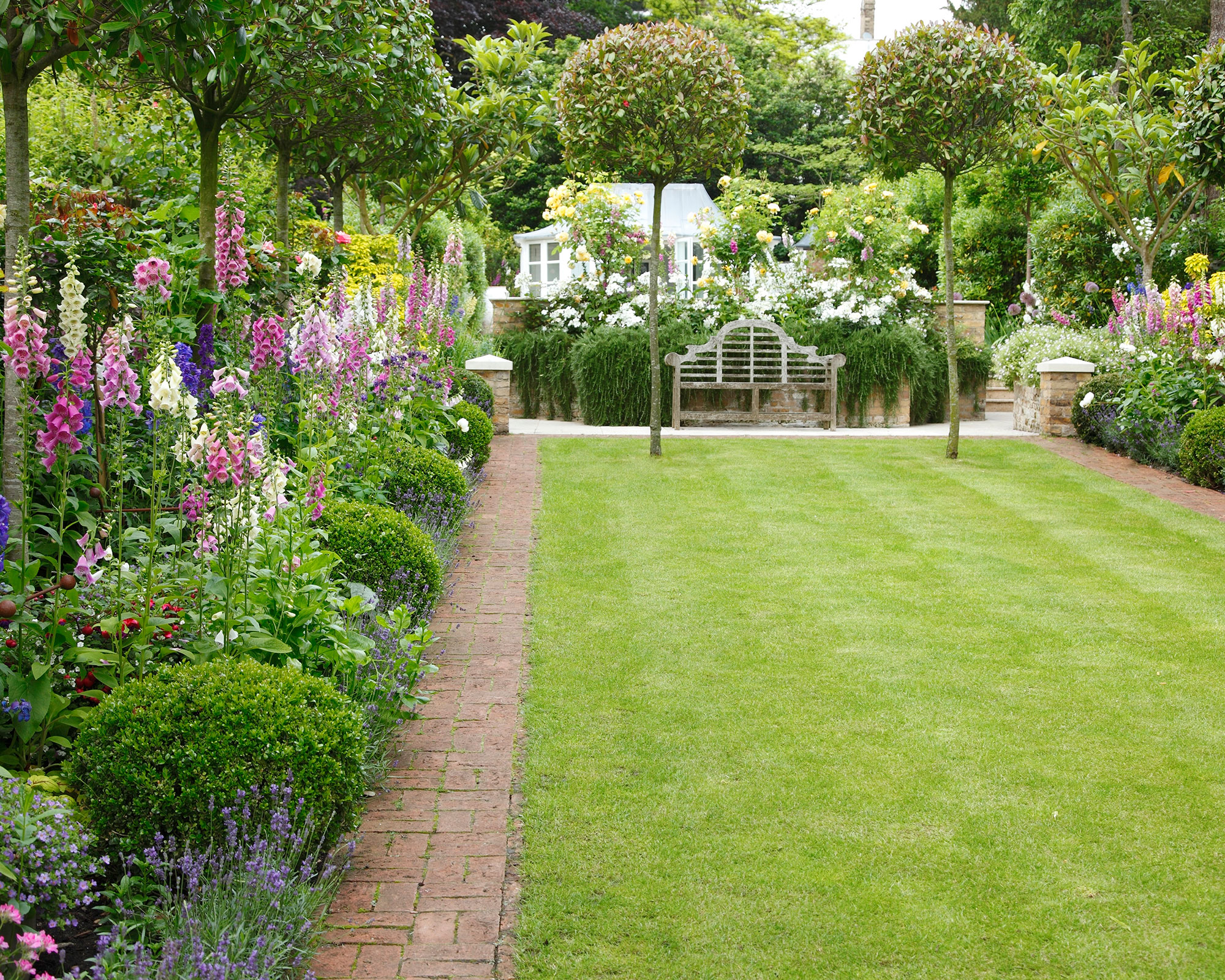 English garden with smart topiary and flower borders