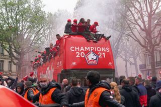 Lille's players celebrate their Ligue 1 title with an open-top bus parade through the city centre in 2021.