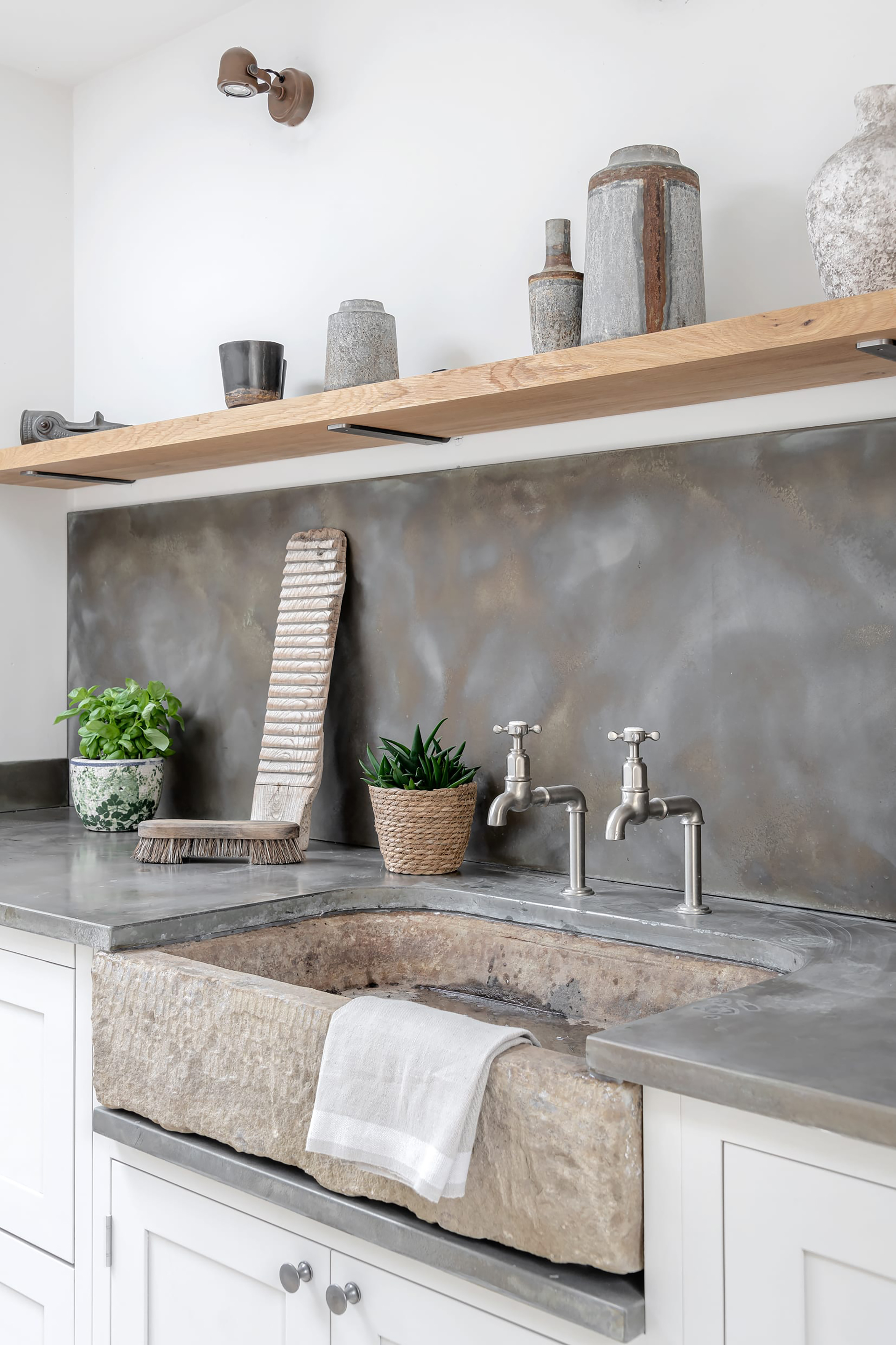 rustic kitchen with stone sink and industrial aged zinc worktop