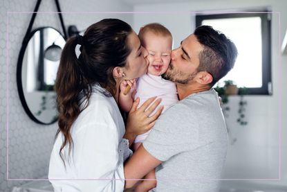 Couple holding their baby together