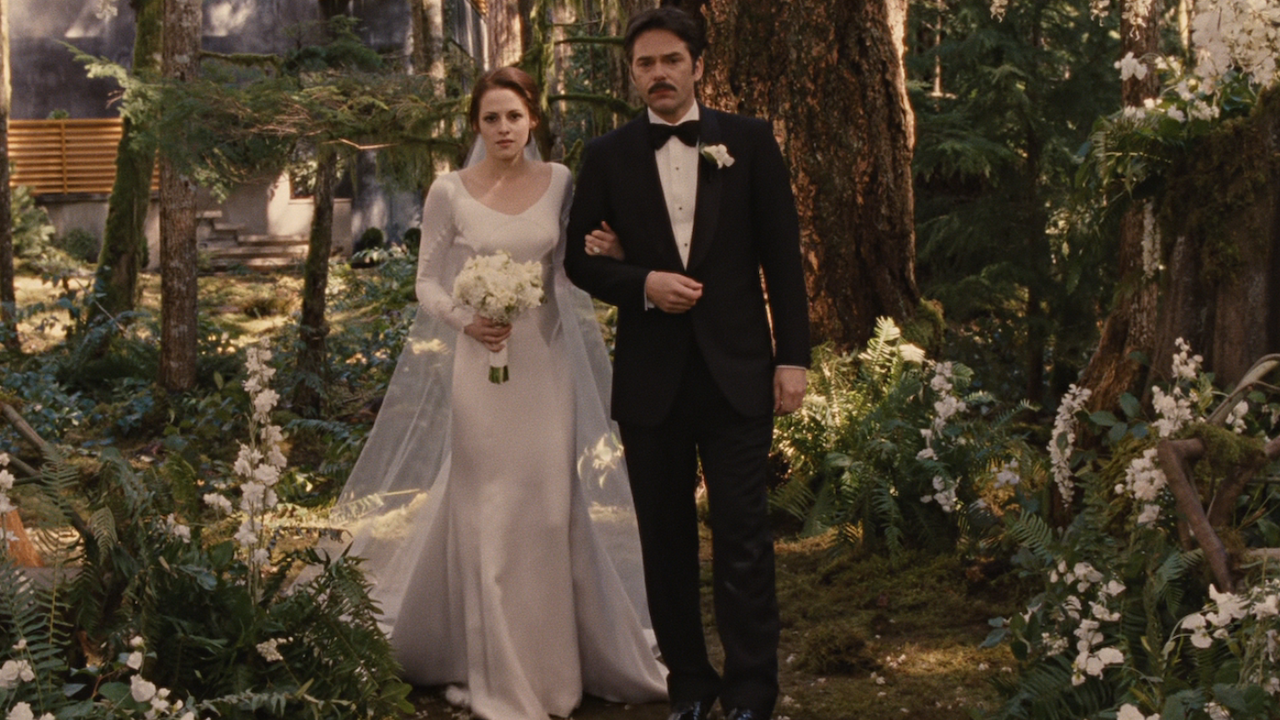 Kristen Stewart as Bella Swan being walked down the aisle by Billy Burke's Charlie Swan at wedding in Breaking Dawn Part 1
