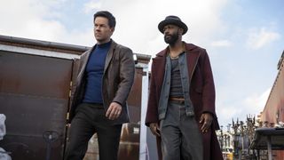 Parker and Grofield standing as they look at something off-camera in Play Dirty