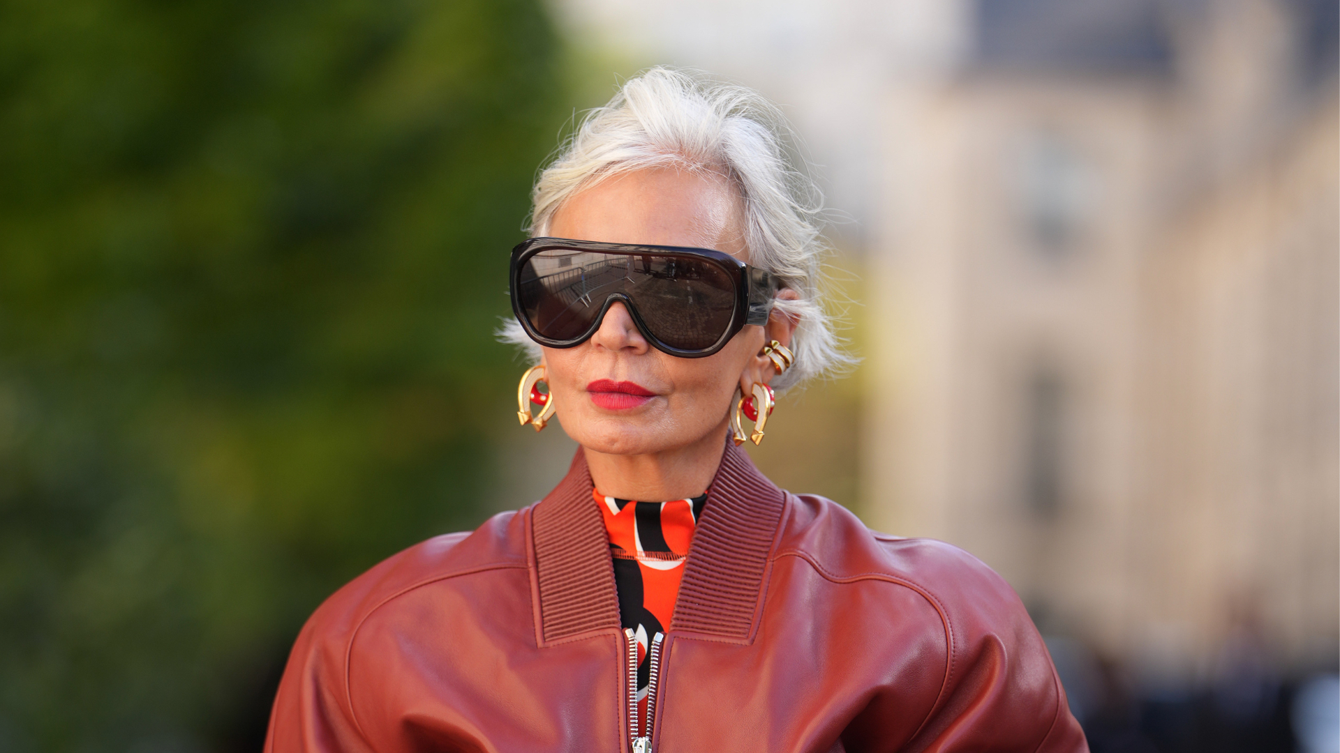 Best blush for mature skin Grece Ghanem wears short platinum-blonde hair with a side part, oversized black futurist sunglasses, gold hoop earrings, a gold cuff bracelet, gold rings, a tan leather bucket Picotin bag from Hermes with drawstring and gold hardware, a burgundy leather bomber jacket with ribbed collar and front zipper, a red and black high-neck printed top, a grey wool midi skirt with a center-front panel, outside Hermes, during Paris Fashion Week - Womenswear Spring Summer 2026, on October 04, 2025 in Paris, France
