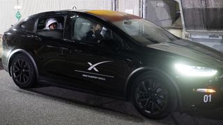 closeup of a black car with a white "X" on its door